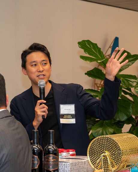 Chang Lim speaking with a microphone at a bar association event